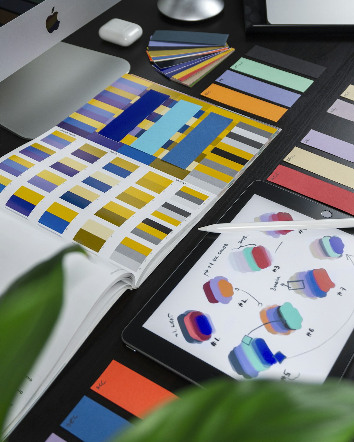 Creative workspace with graphic design tools and digital tablet
