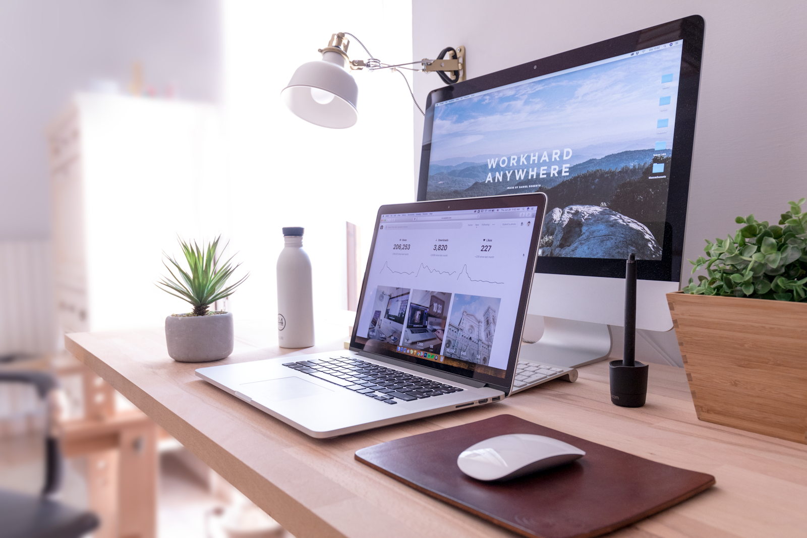 Freelance copywriter working on a laptop at a desk with a coffee cup, representing a work from home copywriting side hustle in 2026