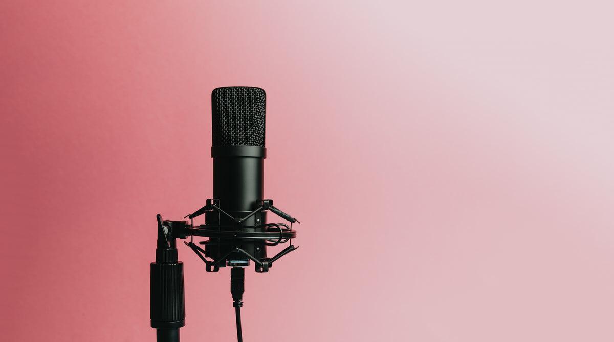 Podcast microphone on a stand representing the podcast editing side hustle