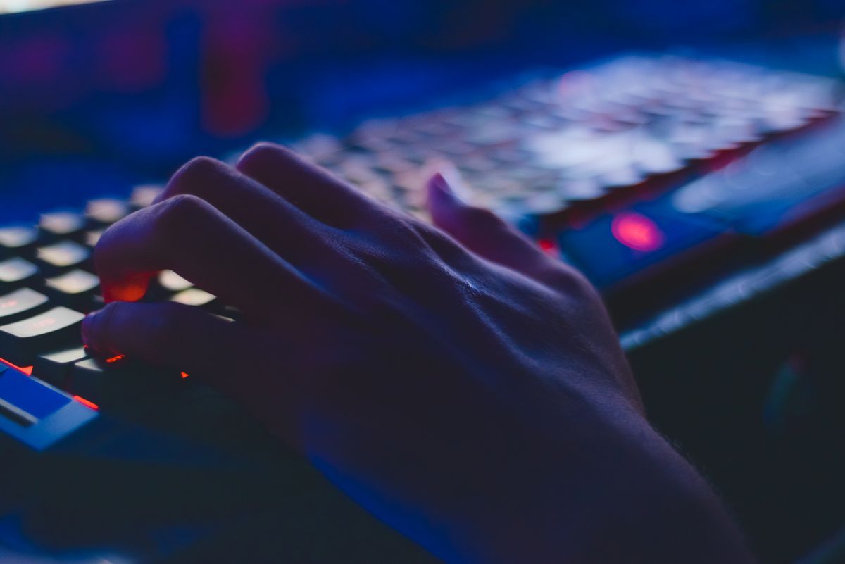 Person typing code on a laptop screen - freelance technical writing side hustle